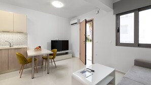 A modern living space with a kitchen, dining area, and seating area. - Rhodes Luxury Apartments (Rhodes)