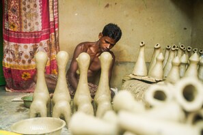 A person working with pottery. - Hotel Annapurna (Bishnupur)