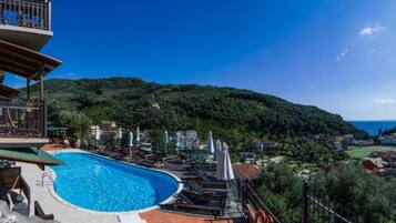 Seasonal outdoor pool, open 10:00 AM to 8:00 PM, pool umbrellas