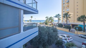 A modern building with a balcony overlooking a street and a body of water. - First line / Wifi / Spa / Seaviews / Heated pool / Pets (Calpe)