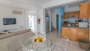 A modern apartment with a living room, kitchen, and dining area.