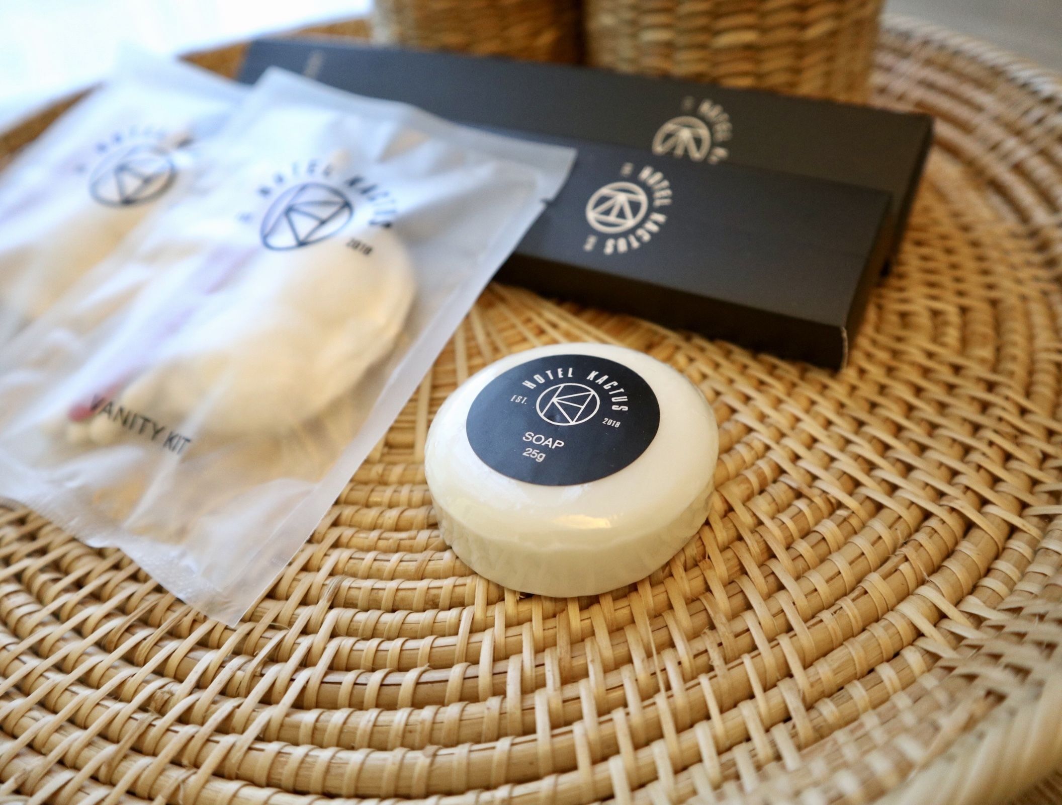 A soap bar and a box on a woven mat.
