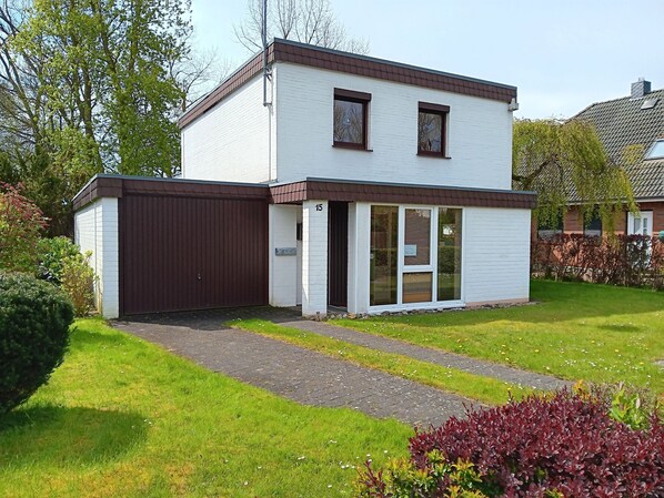 A two-story house with a garage, a front door, and a small porch area. - Noorblick Vacation Home in Maasholm Bad (Maasholm)