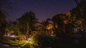 A nighttime view of a resort with illuminated buildings and a starry sky. - El Mirador (Miramar)