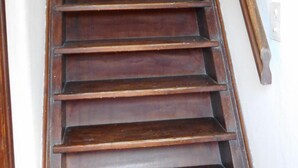 A wooden staircase with a handrail on one side and a wall on the other. - Charming villa in the heart of the maquis          (Bonifacio)