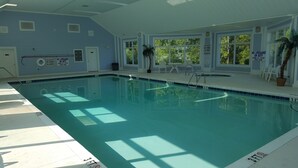 An indoor swimming pool with clear water, marked depth lines, and safety signs. - Beautiful Beach / Golf Villa (Garden City)