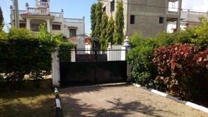 A gated entrance with a paved pathway leading to a building. - SHREE ENCLAVE WEST COURT (Mombasa)