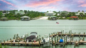 A marina with docked boats, a lifebuoy, and a flag. - Trendy & Tranquil! (Pensacola)