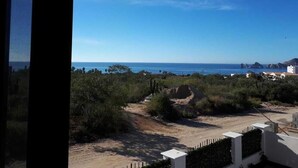 A coastal view with a clear sky, sandy beach, and vegetation. - Gorgeous 2 1/2 Bedrooms  House with a private pool and a Spectacular View (cabo san lucas)