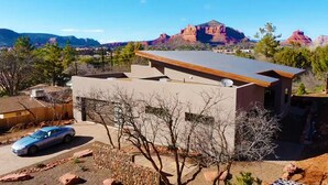 A modern house with a flat roof and a car parked in the driveway. -  Stunning 3 bed, 2 bath home w/Bell Rock and Castle Rock views (Sedona)