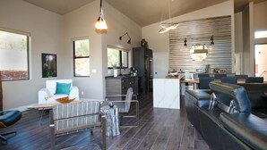 A spacious living area with a modern kitchen, a dining area, and a seating area with a sofa and chairs. -  Stunning 3 bed, 2 bath home w/Bell Rock and Castle Rock views (Sedona)