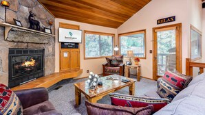 A cozy living room with a stone fireplace, wooden ceiling, and a sign that reads "Relax". - ASHW05 - Charming Home, A/C, Hot Tub,  Bikes (Sunriver)