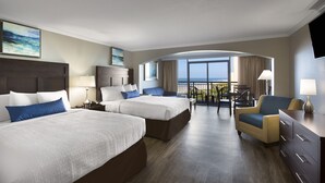 A hotel room with two beds, a desk, a chair, and a balcony with a view of the ocean. - Wonderful Caravelle Resort Ocean View double efficiency (Myrtle Beach)