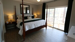 A four-poster bed with a canopy, a large window with a view, and a ceiling fan. - Lakefront Walkout Condo in StillWaters – Stunning Views & Prime Location! (Dadeville)