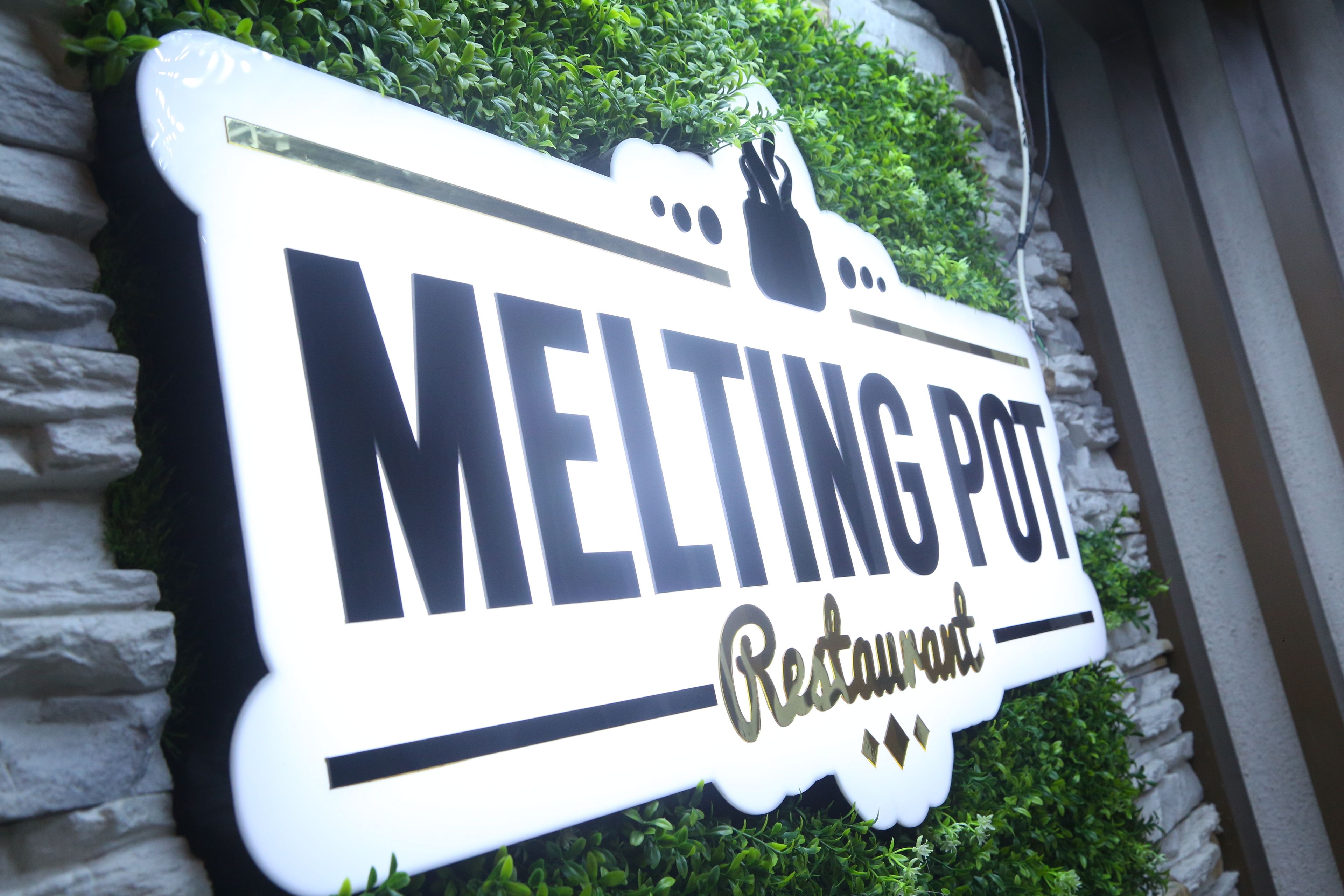 A sign for the Melting Pot Restaurant.