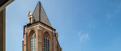 A large brick church with tall windows and a pointed roof.