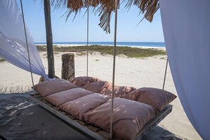 On the beach, sun-loungers
