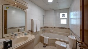 A bathroom with a large mirror, two sinks, a bathtub, and a toilet. - J5 Four Bedroom Villa in Mirdif (Dubai)