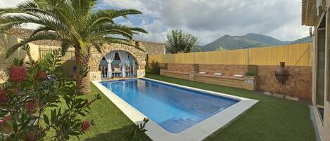 Outdoor pool, open 11:00 AM to 10:00 PM, pool loungers