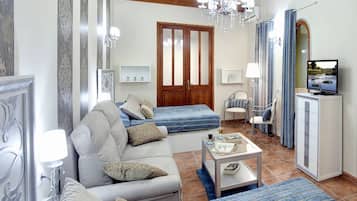 Suite Deluxe, 2 camas matrimoniales, aire acondicionado, vista al patio | 1 habitación, ropa de cama de alta calidad, cunas y wifi gratis