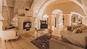 Amplia sala de estar con chimenea, sofás y una mesa de centro.