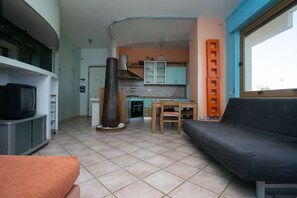 A compact living space with a kitchenette, a dining area, and a seating area.