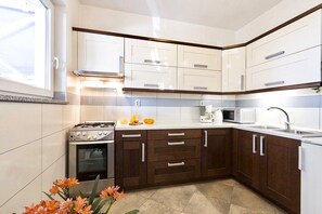 Enjoy cooking in this well-equipped kitchen with oven, microwave, and sink.