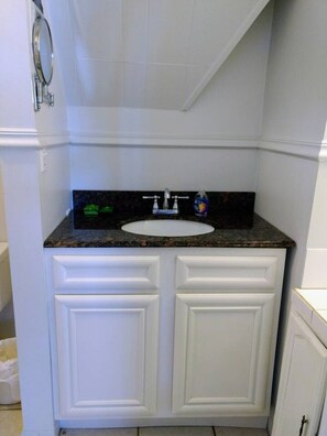 A bathroom with a white vanity, a sink, a mirror, and a faucet. - Unit C - Pet Friendly! (Orange Beach)