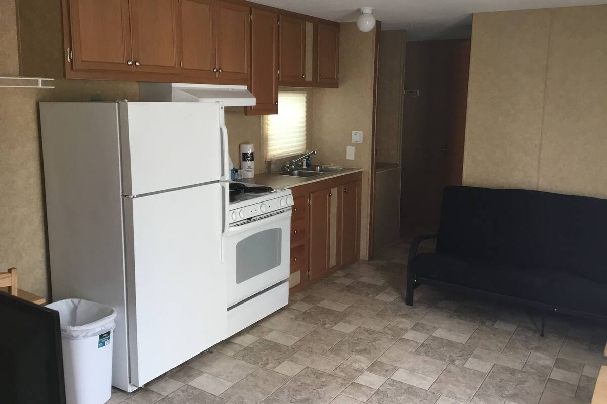 Deluxe Mobile Home, Multiple Beds | Private kitchen | Full-size fridge, microwave, stovetop, cookware/dishes/utensils