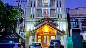 The exterior of the Royal Ruby Hotel with a prominent entrance and a sign above the doors. - Royal Ruby Hotel (Mandalay)