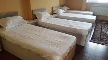 Standard Quadruple Room | In-room safe, desk, laptop workspace, blackout drapes
