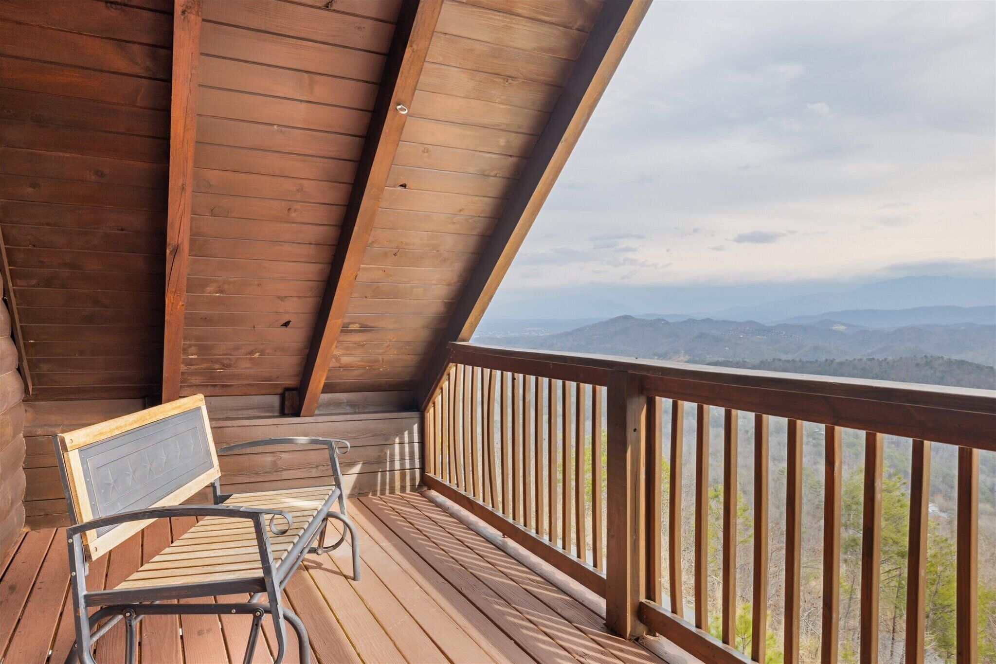 A wooden deck with a view of mountains.