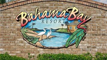 A mural of a beach scene with the text "Bahama Bay Resort" on a brick wall.
