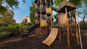 A playground with a slide, climbing structures, and a swing set. - On the beach! - Marriott Oceanwatch Villas in Myrtle Beach, SC! (Myrtle Beach)
