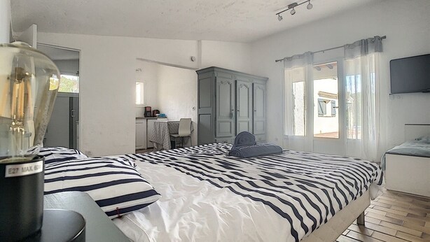 A bedroom with a bed, a desk, a chair, a wardrobe, and a television. - Splendid Sea View Villa near St-Tropez - Pool, AC, Sleeps 10 (Cavalaire-sur-Mer)