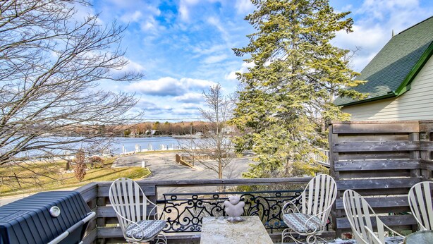A patio with a grill, two white chairs, and a table. - Luxury Harbor Front Home In Town Chef's Kitchen 4 Ensuite King Rooms + 1/2 bath (Saugatuck)