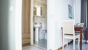 A bathroom with a sink, toilet, and cabinet. - Studio in the city center with private parking (AREZZO)