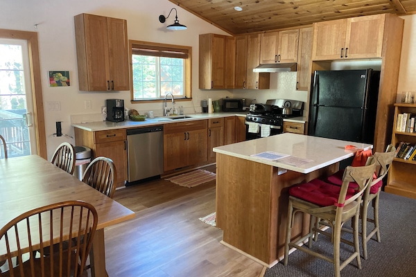 Updated modern open kitchen with gas range and dishwasher