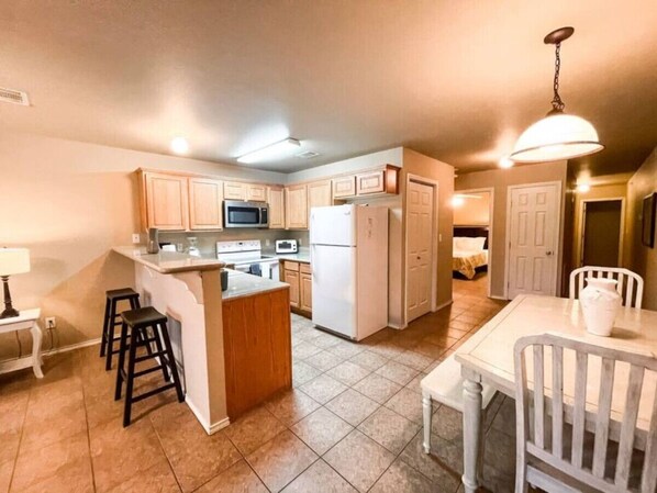 Fridge, microwave, coffee/tea maker, cookware/dishes/utensils