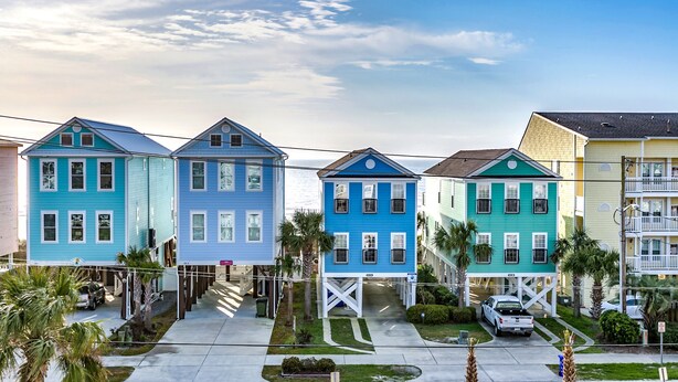 A row of colorful houses with a clear sky. - Surfside Beach steps away from beach 8/11-8/15; 8/22-8/28; 9/8-9/20; 10/4-10/30 (Surfside Beach)