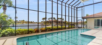 Spacious, waterfront home with dock, heated pool, and lanai