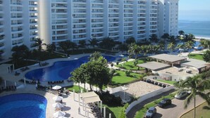 A hotel with multiple floors, a swimming pool, and a view of the ocean. - Villa Magna 1 Bedroom Tower 3 on 2nd Floor Oceanfront Sleep up to 4 (Nuevo Nayarit)