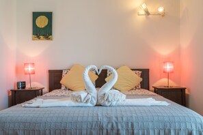 Cozy retreat with a large bed, two bedside tables, and a warm glow from the lamps.