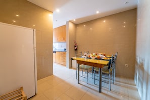 Enjoy meals in the well-appointed kitchen and dining area with a wooden table and four chairs.