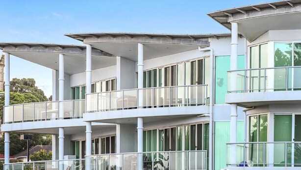 A modern multi-story building with balconies and large windows. - 3BR Penthouse w/ Ocean Views – Pool, Spa Bath, Tennis Court & Secured Parking | Ideal for Extended Stays (Victor Harbor)