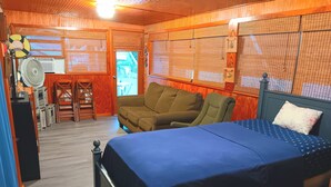 A bedroom with a bed, a sofa, and a desk with a chair. - Key largo waterfront jewel (Key Largo)