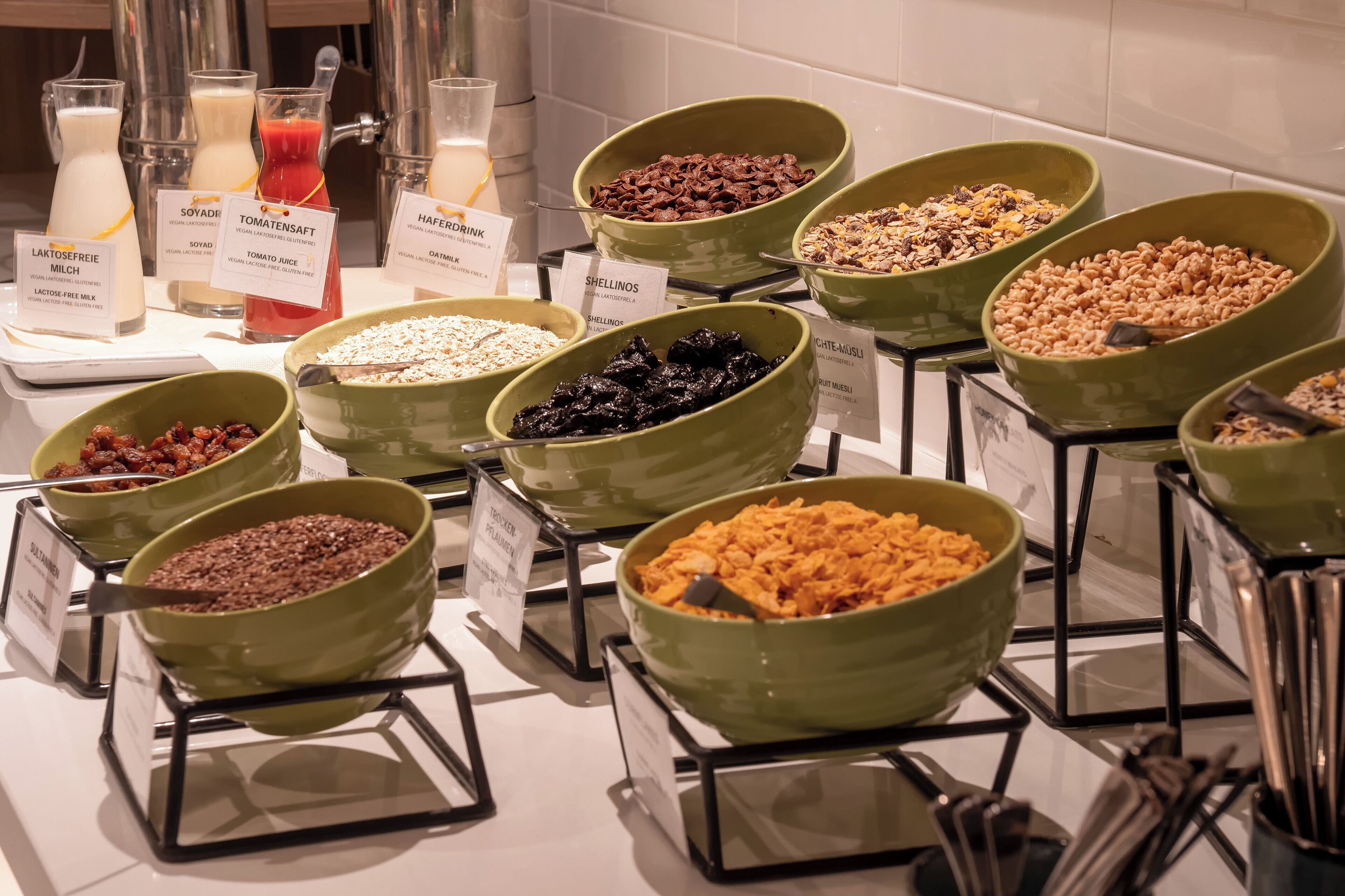 A breakfast buffet with various food options and drink dispensers.