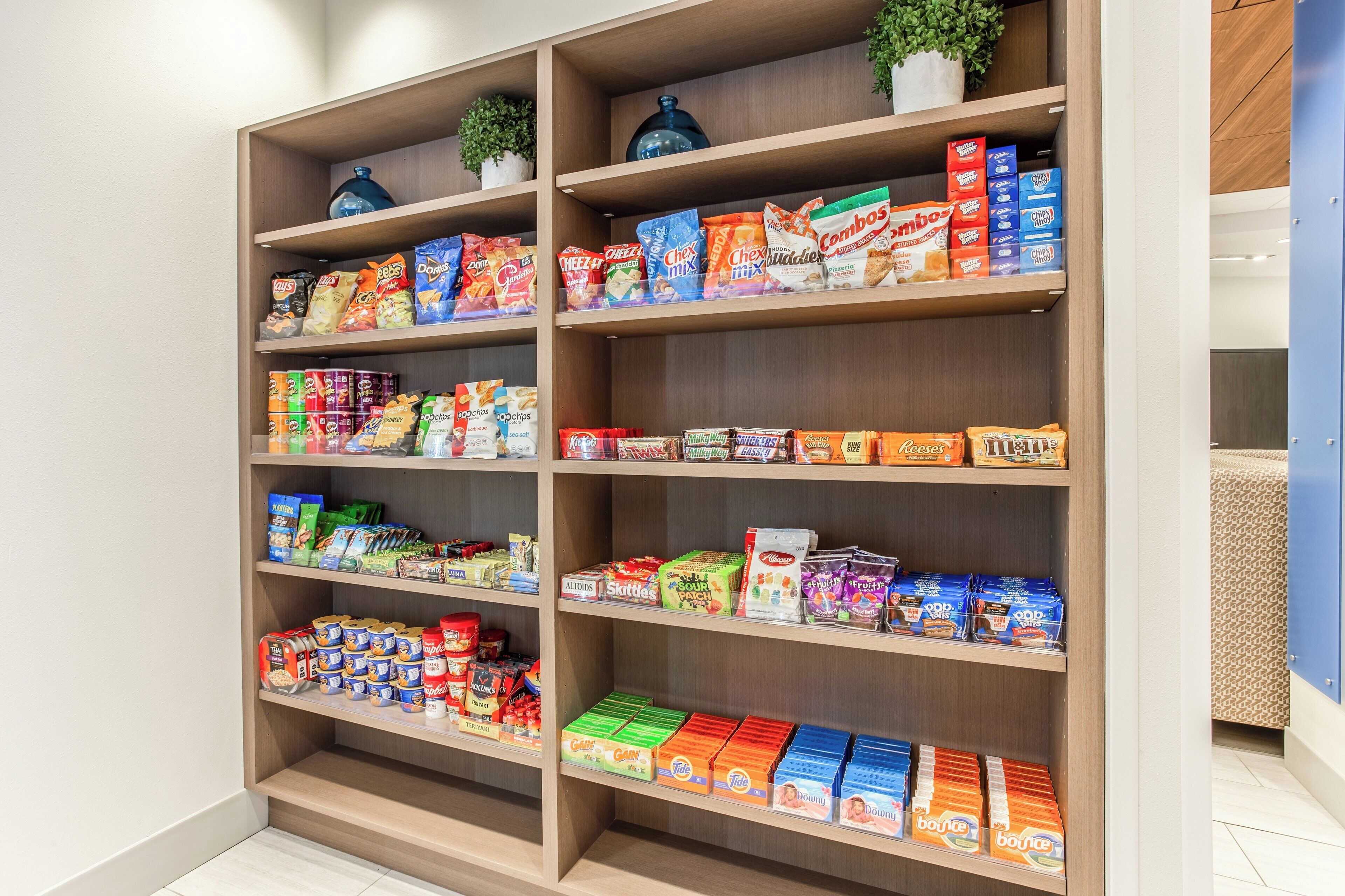A well-organized snack and food aisle in a store with various packaged goods.