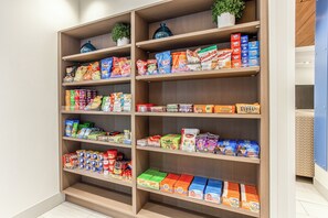 A well-organized snack and food aisle in a store with various packaged goods.