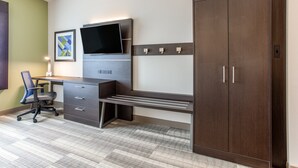 A modern office space with a desk, chair, and wardrobe.